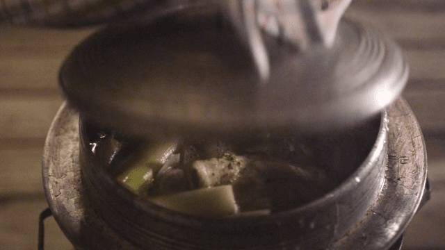 Simmering Traditional Chicken Soup in Small Cauldron