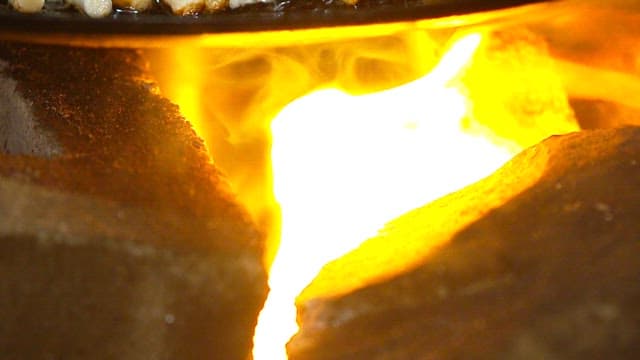 Appetizing seafood pancake sizzling in a hot pan over a fire