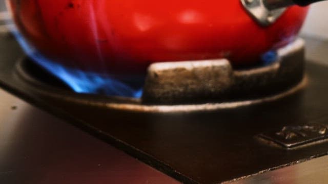 Cooking with a Red Frying Pan on a Gas Stove