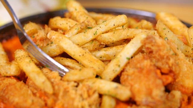 Crispy fries and fried chicken on a plate