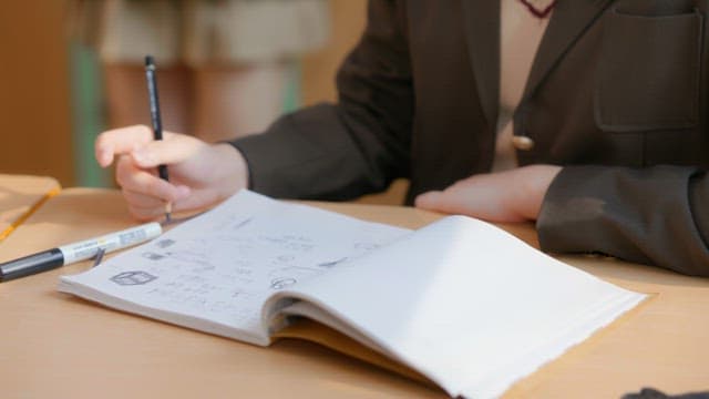 Student writing notes in a classroom