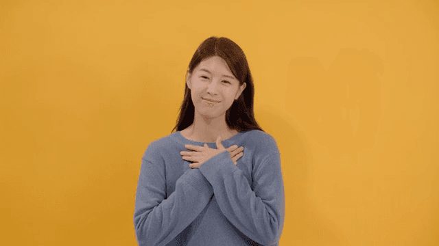 Woman expressing gratitude with a sincere smile and hand on her heart