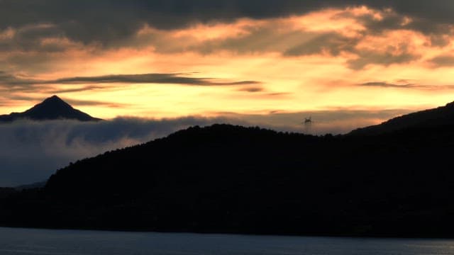 Sunset over mountains with clouds