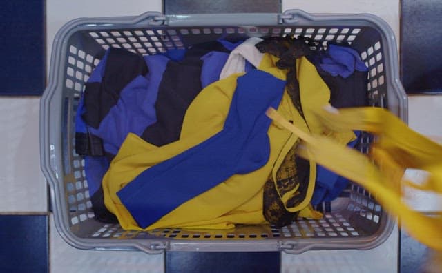 Sorting laundry in a basket with various colors