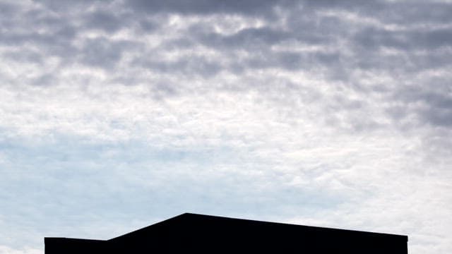 Silhouette of a Building Against Cloudy Sky