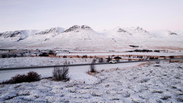 Snowy mountains and road with cars