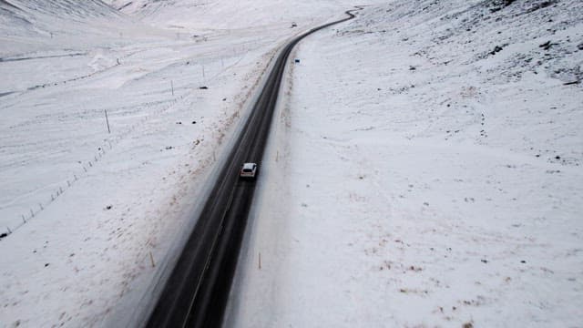 Car driving on a snowy mountain road