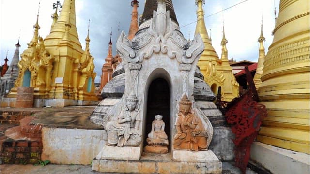 Serene Buddhist Temple Featuring Statues and Pagodas