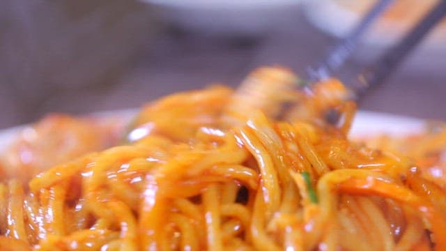 Appetizing and spicy stir-fried jjambbong mixed with chopsticks