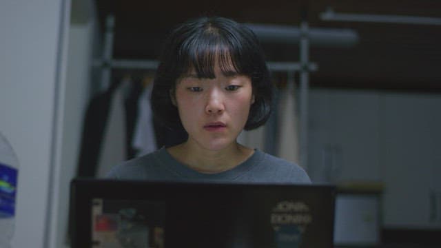 Woman using laptop in a dimly lit room