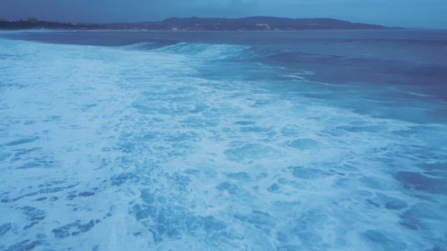 Waves crashing on a vast ocean shore