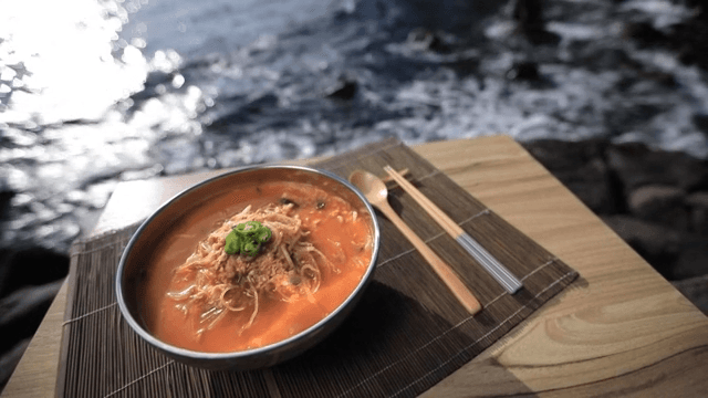 Bowl of spicy fish porridge with flounder by the sunny sea