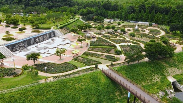 Landscaped park with green forest in the background