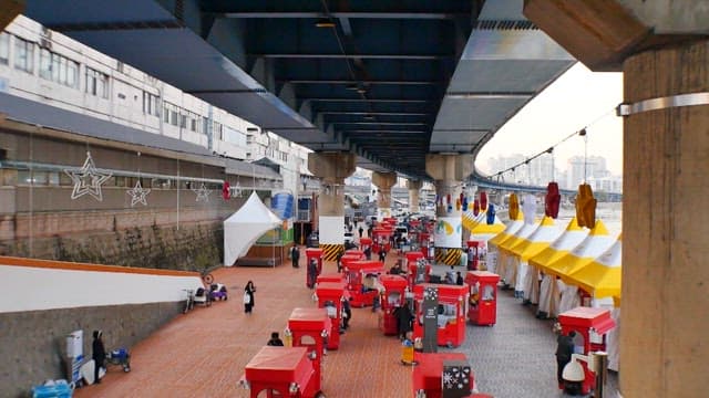 Outdoor Market Under Bridge with Festive Decor