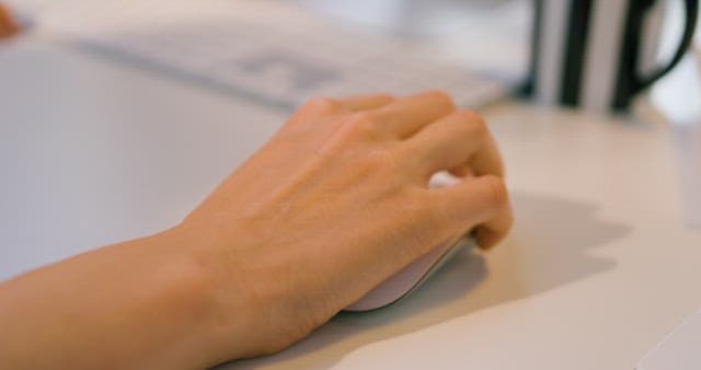 Hand Using Wireless Mouse on the Desk
