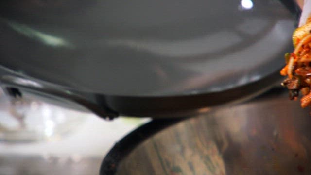 Seasoned oyster mushrooms and pork in a frying pan