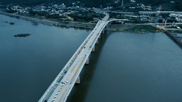 Bridge over a river with cars moving