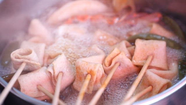 Fishcake skewers soup with various ingredients