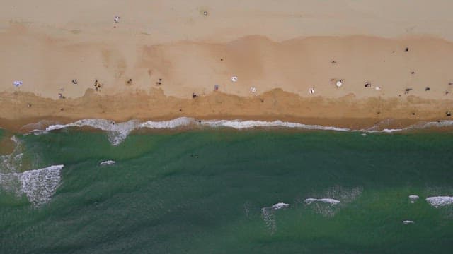 Wavy beach with summer vacationers