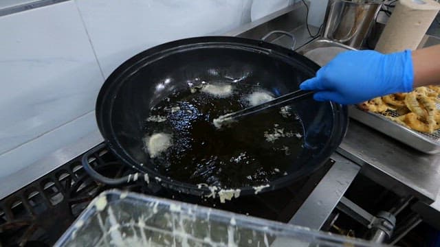 Deep frying webfoot octopus in hot oil