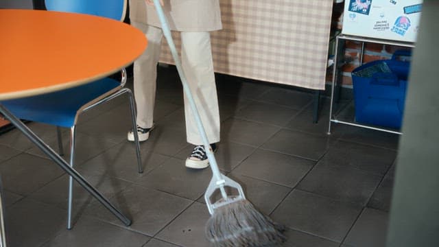 Woman cleaning a pizza shop