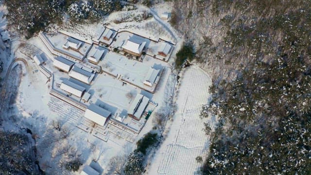 Snow-covered traditional village nestled in a mountains