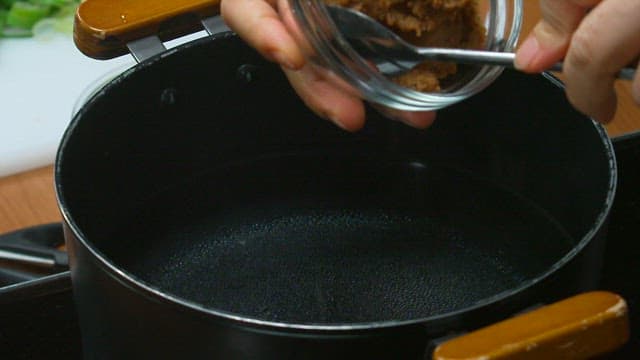 Adding paste to a pot of boiling water