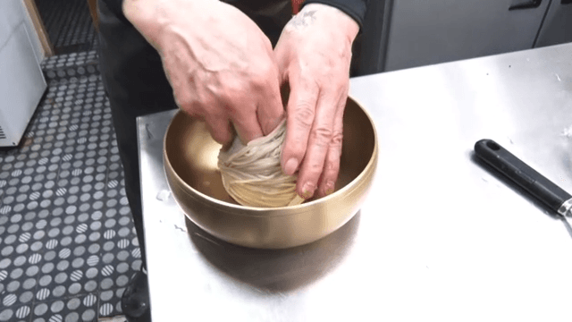 Noodles arranged neatly in an brassware for cold noodles