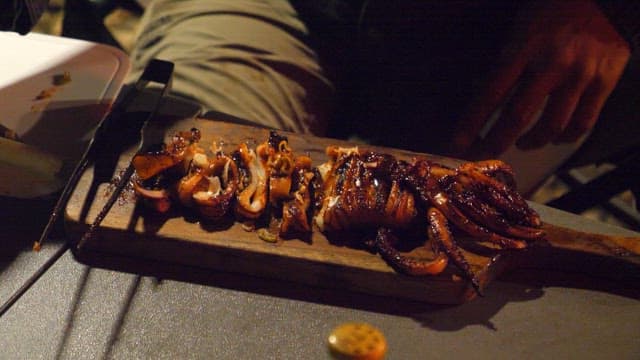 Grilled Squid Being Served at Night