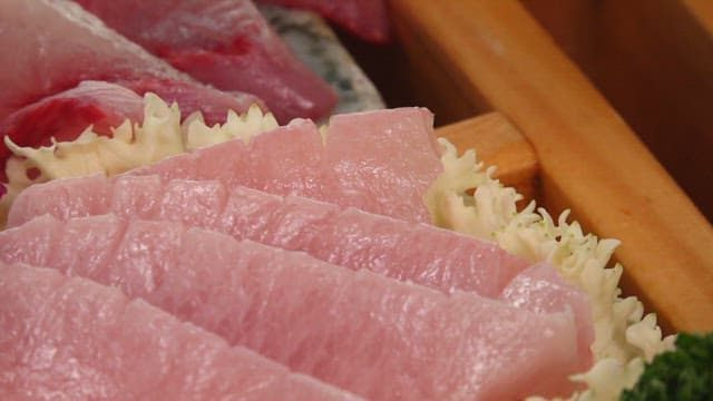 Freshly sliced yellow tail sashimi on a plate