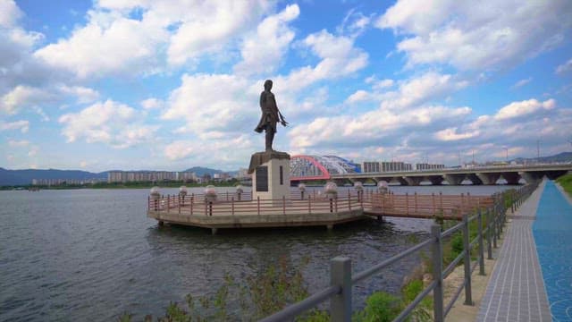 Quiet river view with a statue and bridge