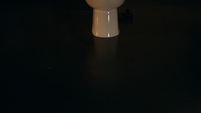 Glowing toilet with UV lamp in a dark room