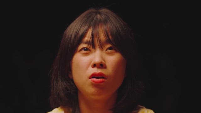 Woman deeply contemplating in a dark room