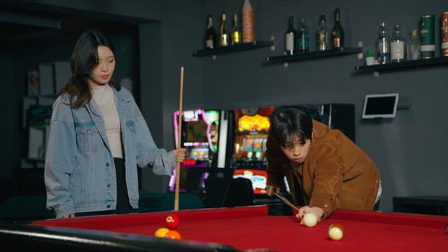 Friends Competing in a Game of Pool