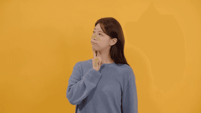 Woman lost in thought, resting her finger on her chin