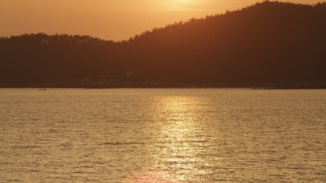 Sunset over a serene coastal landscape