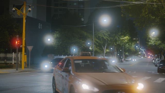 Cars driving on a road near a quiet residential complex