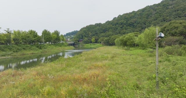Serene riverside with a traditional pavilion