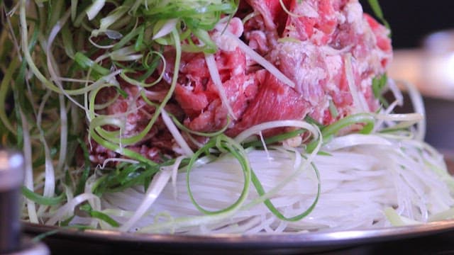 Raw meat and vegetables in a bowl for a hot pot dish preparation