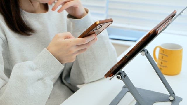 Woman using smartphone at a desk