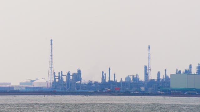 Coastal view of an industrial complex on a hazy day