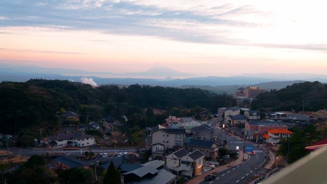Small town at dusk with city lights