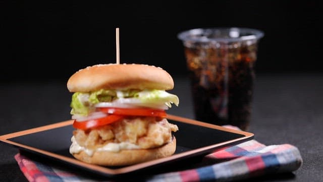 Hamburger with fried pork, tomato and garlic mayonnaise sauce and cola