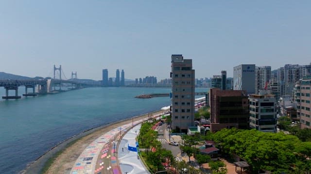 Busan, coastal city with numerous buildings along the beach on a clear day