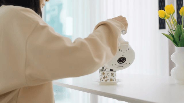 Making drip coffee by pouring water with coffee pot at a white table