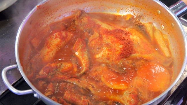 Steamed fish containing various fish simmering in a pot
