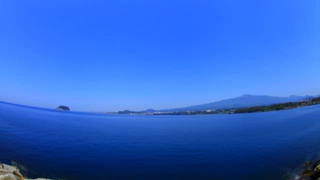 Panoramic Coastal Landscape Under Blue Sky