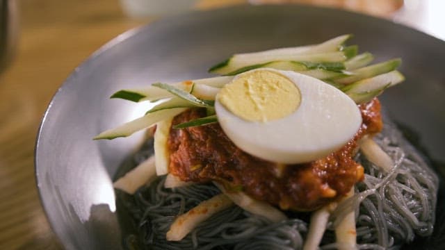 Succulent cold noodles topped with sauce and egg