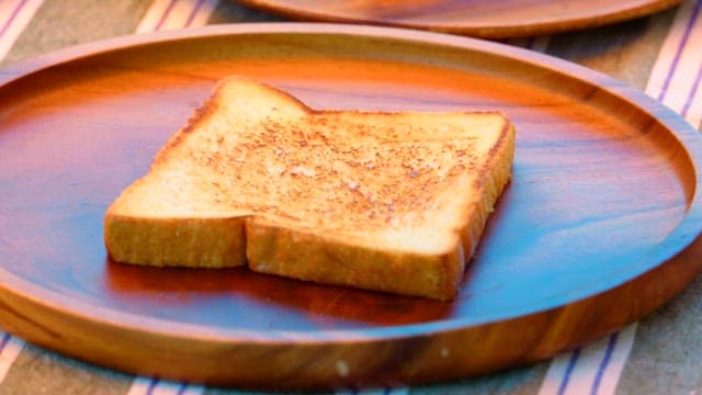 Preparing a simple toast with ketchup and omelette outdoors