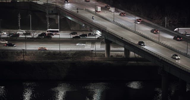 Illuminated City Traffic on Bridges and Roads at Night